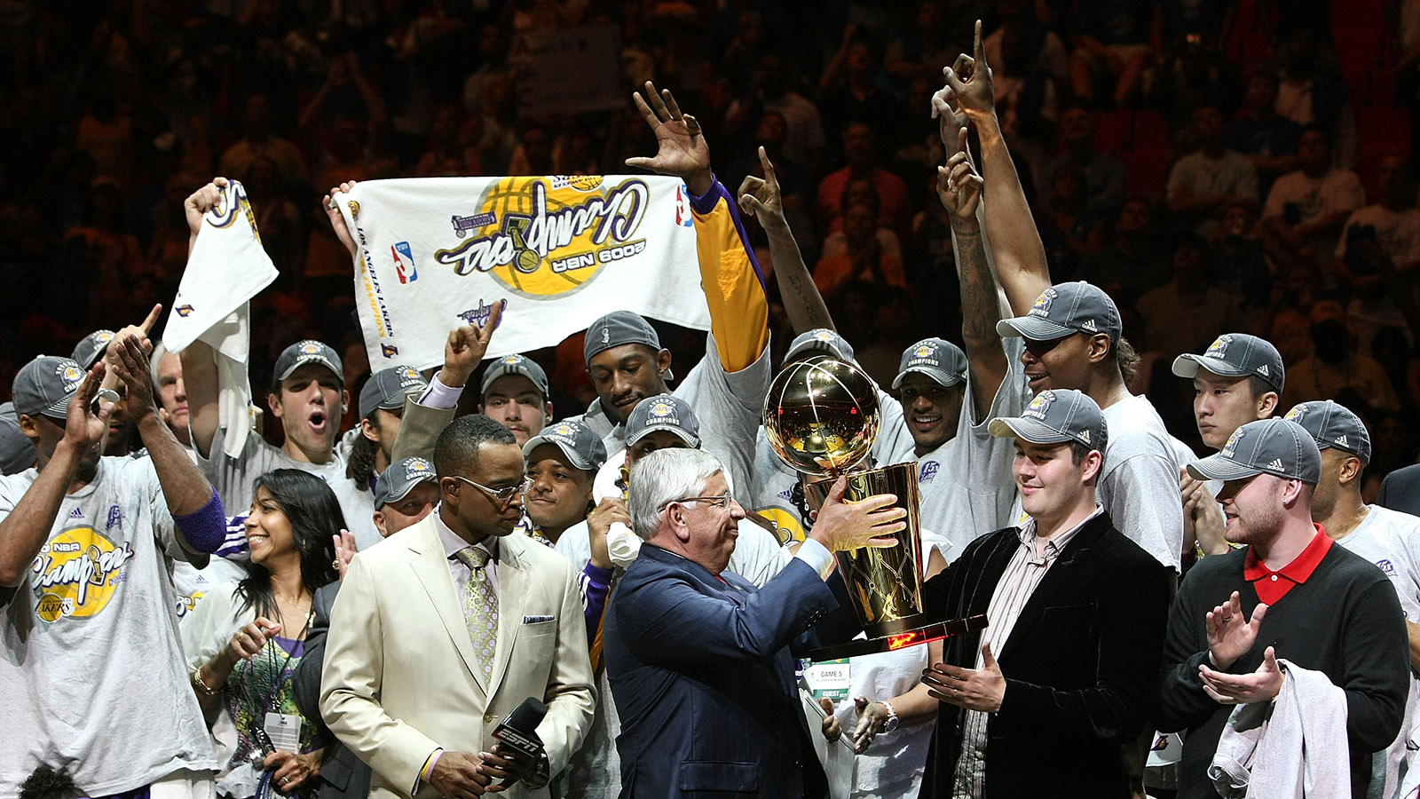 Joey Buss accepts the Larry O'Brien Trophy from David Stern